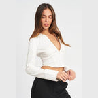 Emory Park stylish deep v neck blouse in white, featuring a cropped design and long sleeves