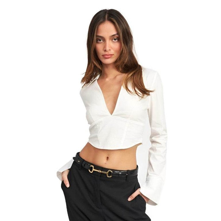 Emory Park stylish deep v neck blouse in white, featuring long sleeves and a cropped design.