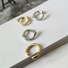 ClaudiaG Collection stylish ear cuff for vacation in gold and silver options displayed on a book