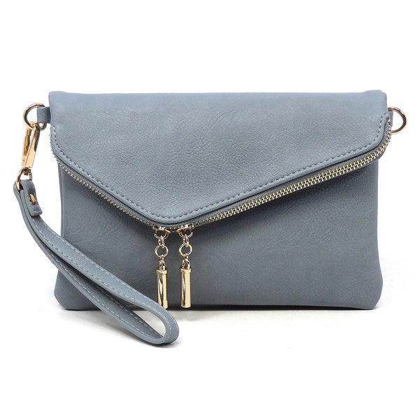 Stylish handbag for vacation in light blue with a zippered closure and detachable wrist strap
