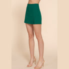 VacationGrabs stylish high waist mini skort in green worn with nude heels for women