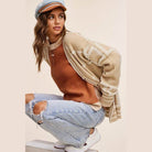 La Miel stylish knit cardigan in beige layered over a rust-colored top with wide-leg jeans