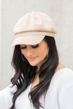 Aili's Corner stylish newsboy hat in beige worn by a woman with long dark hair and hoop earrings