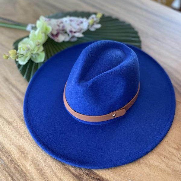 Stylish panama hat in vibrant blue with a brown leather band for a chic look