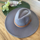 Stylish panama hat in gray with a brown leather band for fashionable women's accessories