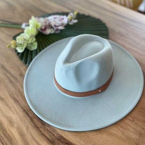 Stylish panama hat in light blue with a tan band, perfect for summer outfits