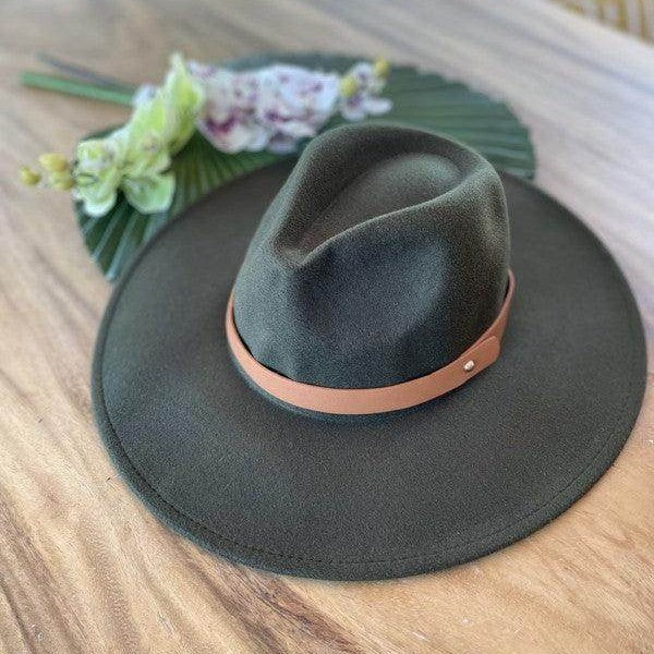 Queens INC stylish panama hat in olive green with a leather band on a wooden table