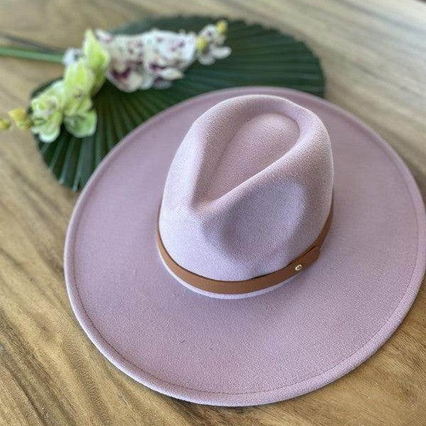 Stylish panama hat in soft pink with a brown leather band for trendy women's fashion
