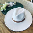 Stylish panama hat with a wide brim and brown leather band, perfect for summer outings