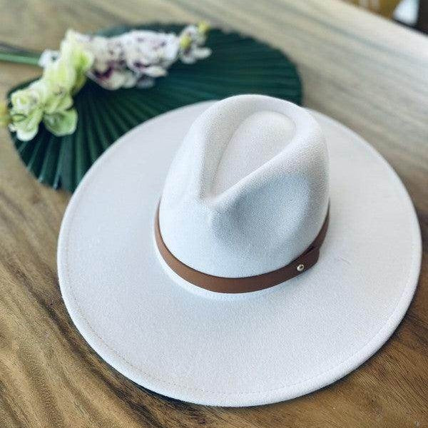 Stylish panama hat with a wide brim and brown leather band, perfect for summer outings