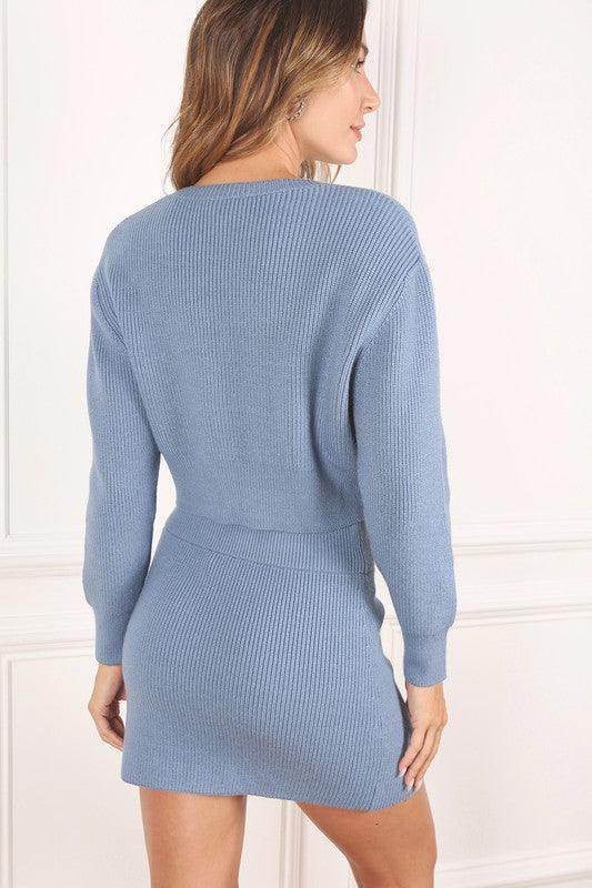 Back view of a stylish ribbed knit ensemble in blue, featuring a fitted design and long sleeves