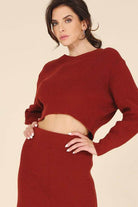 Stylish ribbed knit ensemble in rust color featuring a cropped sweater and matching skirt