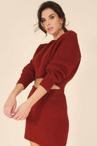 Stylish ribbed knit ensemble in rust color featuring a cropped top and matching skirt