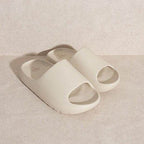 Stylish slip-on sandals in light beige color with open toe design for casual comfort