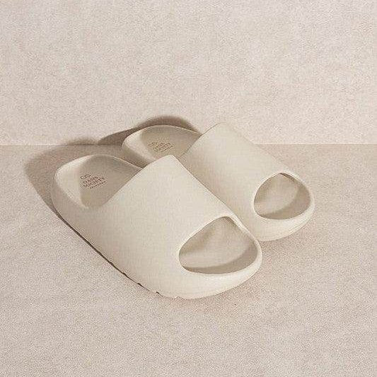 Stylish slip-on sandals in light beige color with open toe design for casual comfort
