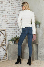 Back view of a stylish vacation blouse from Andante USA paired with fitted jeans and boots
