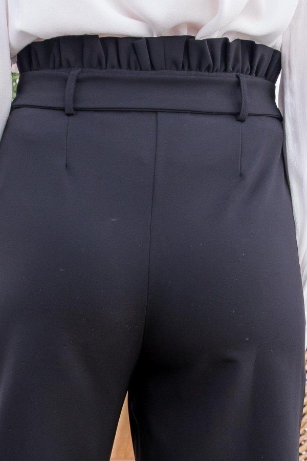 Close-up of black stylish vacation pants for women with a gathered waistband and belt loops