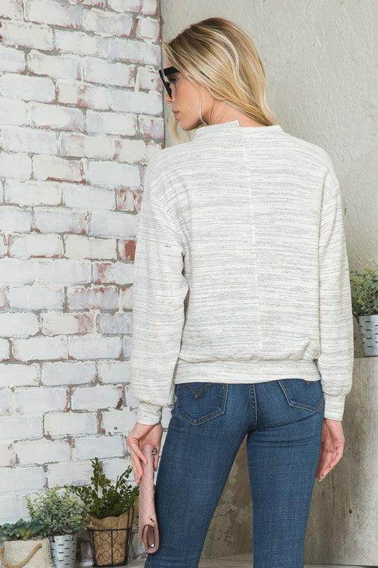 Back view of a light-colored Andante USA stylish vacation tops for women with relaxed fit and long sleeves