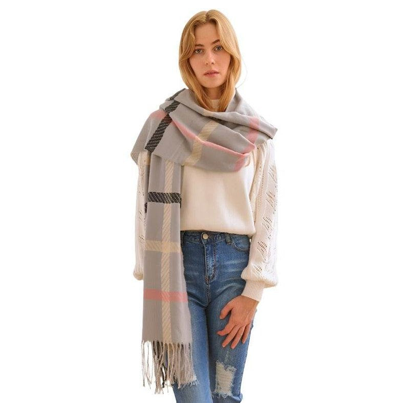 Stylish winter scarf for vacations in grey plaid pattern, perfect for chilly weather and fashion-forward looks.