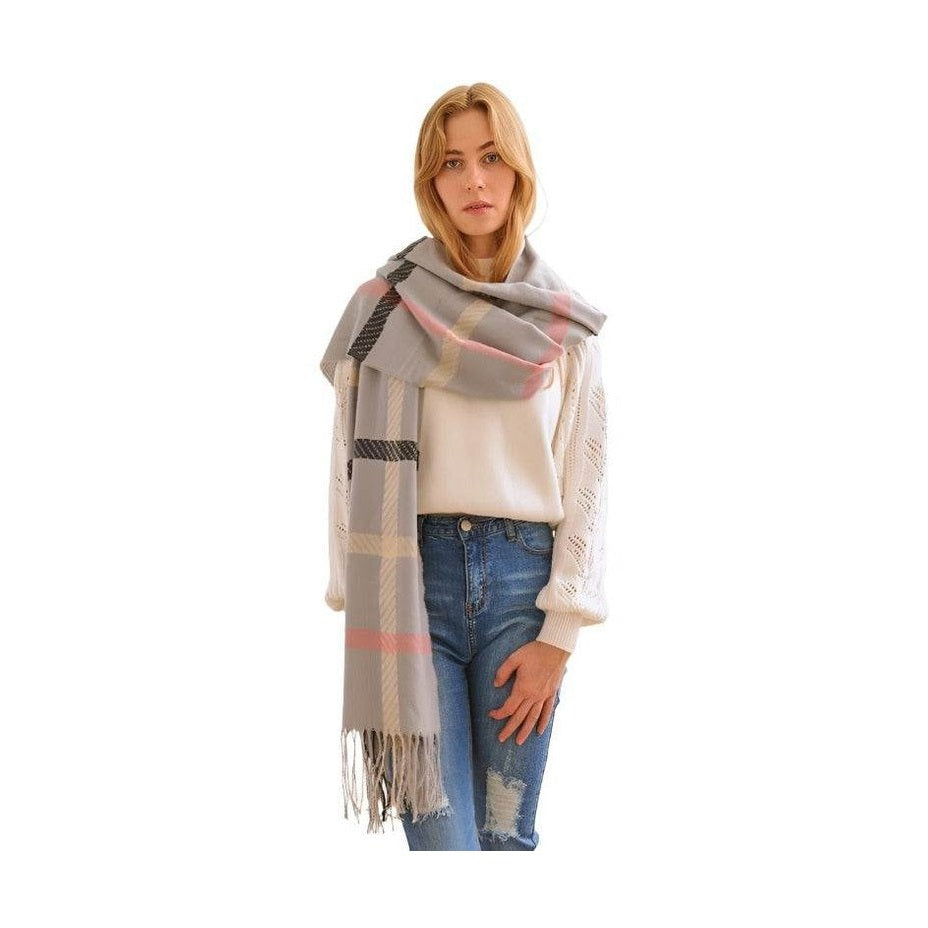 Stylish winter scarf for vacations in grey plaid pattern, perfect for chilly weather and fashion-forward looks.