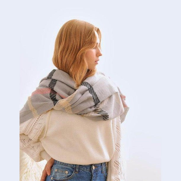 Bella Chic stylish winter scarf for vacations wrapped around a model's shoulders