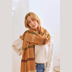 Bella Chic stylish winter scarf for vacations wrapped around a model in a cozy setting
