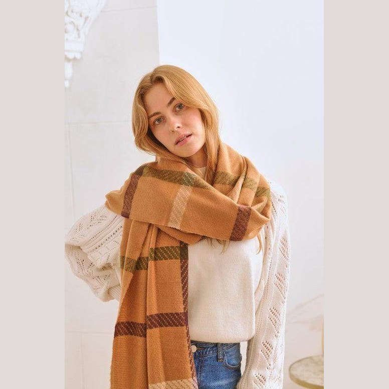 Bella Chic stylish winter scarf for vacations wrapped around a model in a cozy setting
