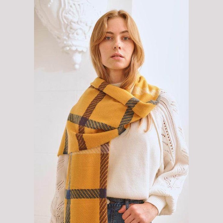 Bella Chic stylish winter scarf for vacations in yellow plaid pattern worn elegantly by a model