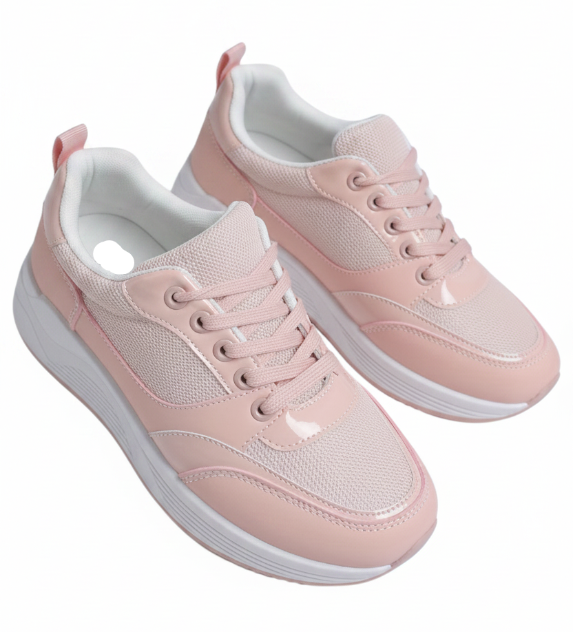 Pink sneakers worn with gray jeans on a white background