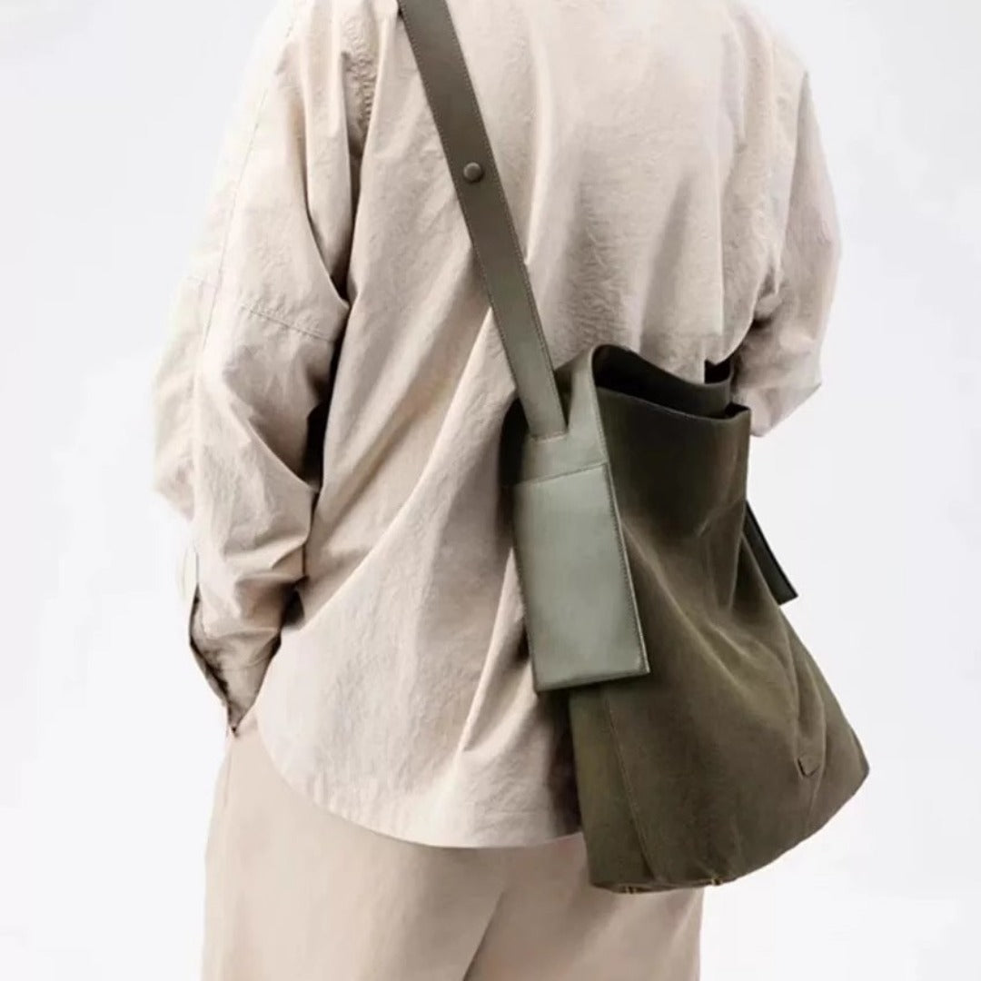 Suede large capacity shoulder bag in olive color worn on shoulder for stylish everyday use