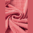 Close-up of pink textured fabric for a summer casual drawstring shorts outfit by SHEWIN INC