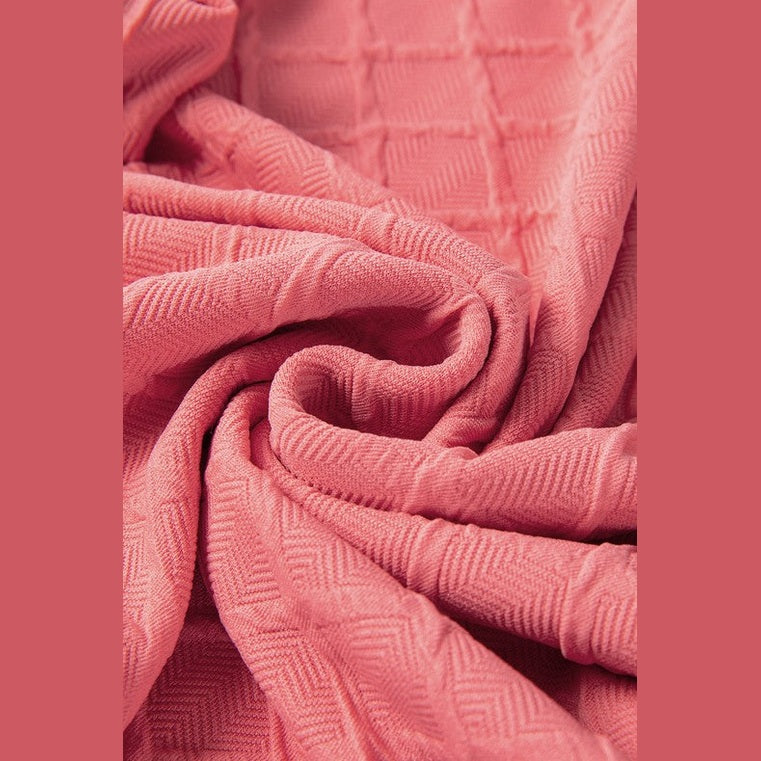 Close-up of pink textured fabric for a summer casual drawstring shorts outfit by SHEWIN INC