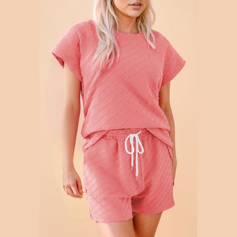 Summer casual drawstring shorts outfit in textured coral pink fabric with relaxed fit and short sleeves