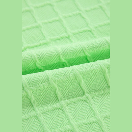 Close-up of textured light green fabric for summer casual drawstring shorts outfit by SHEWIN INC