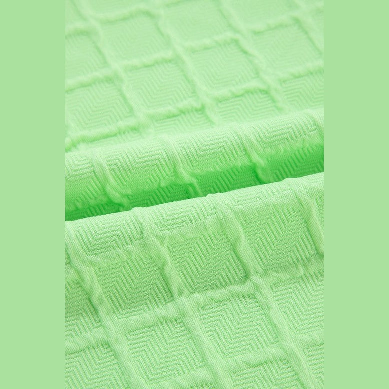 Close-up of textured light green fabric for summer casual drawstring shorts outfit by SHEWIN INC