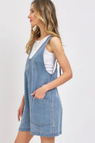 Summer denim romper for women featuring adjustable straps and front pockets in a light blue wash