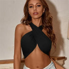 Woman wearing black summer push up bandeau top with crossed straps paired with light denim shorts
