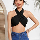 Woman wearing a black summer push up bandeau top with crisscross halter neck and blue jeans