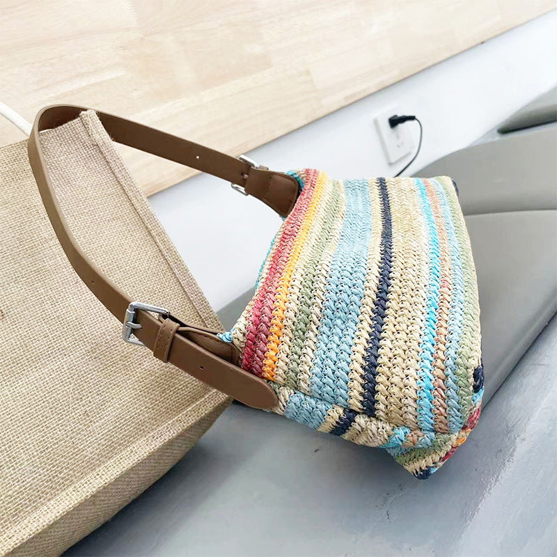 Summer rainbow straw beach bag with a colorful striped design and sturdy handles
