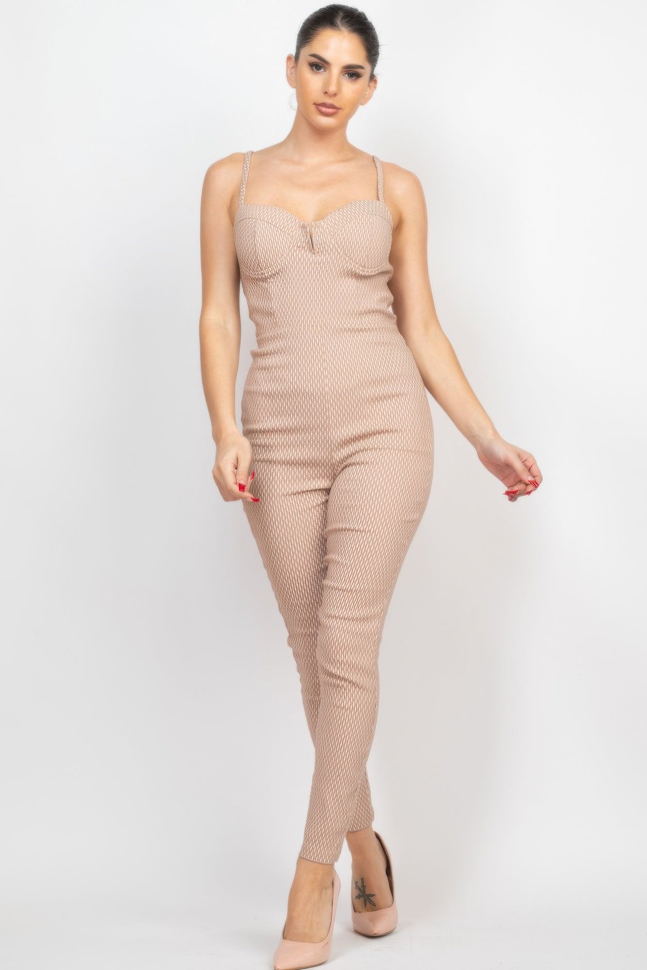 Stylish summer travel jumpsuit for women in light beige with adjustable straps and fitted design
