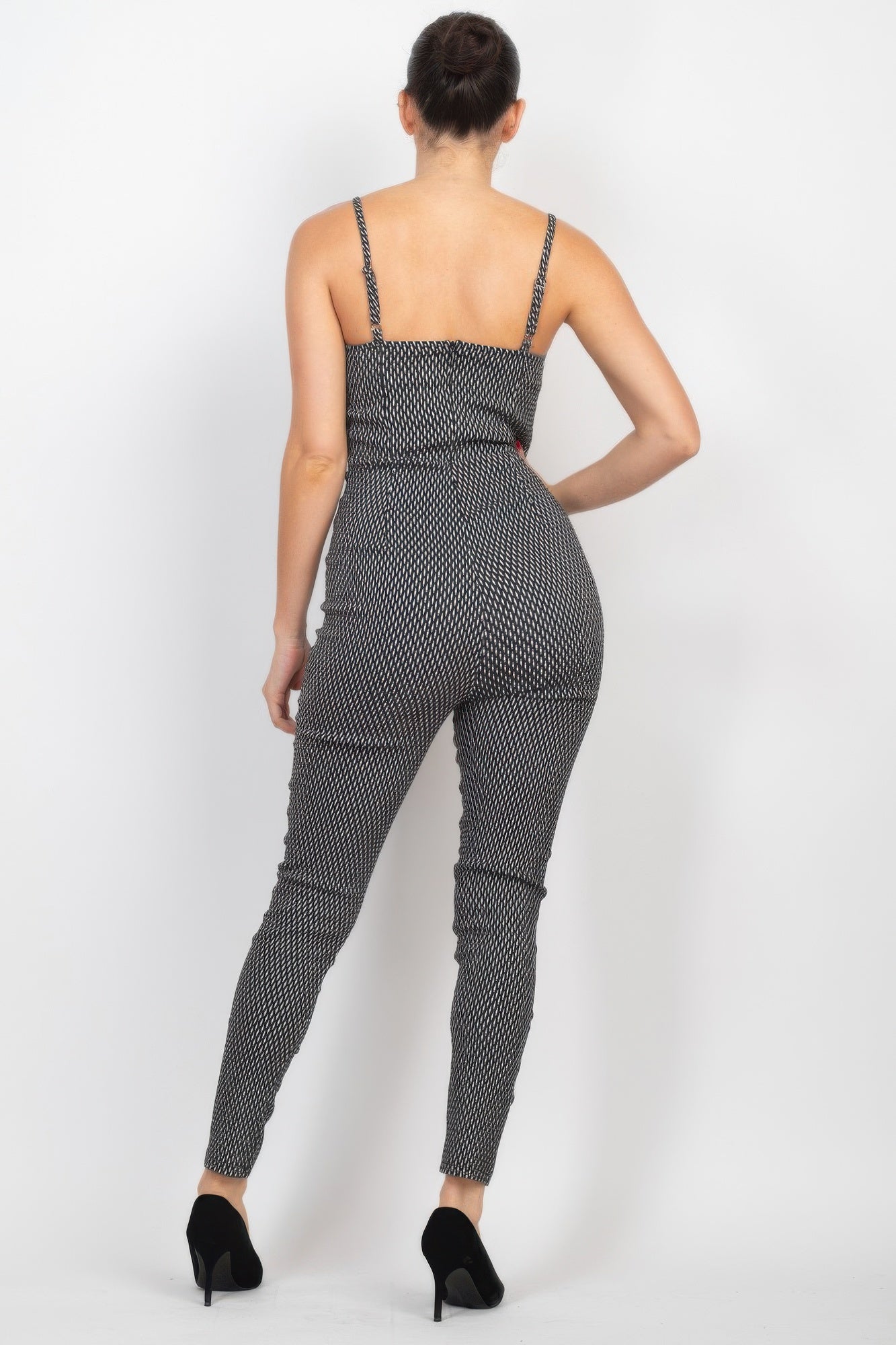 Stylish summer travel jumpsuit for women with a fitted design and adjustable straps in black and white pattern