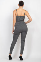 Stylish summer travel jumpsuit for women with a fitted design and adjustable straps in black and white pattern