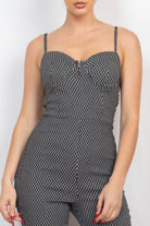 Black and white printed summer travel jumpsuit for women with a sweetheart neckline and slender straps