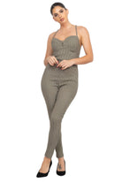 Stylish summer travel jumpsuit for women in a polka dot pattern with a fitted silhouette