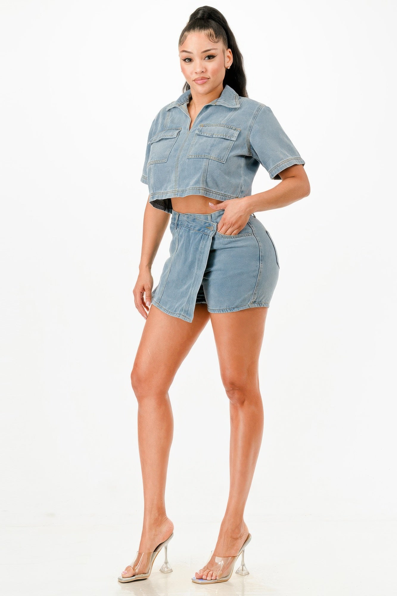 Stylish women's summer travel outfits for women featuring a cropped denim top and matching mini skirt