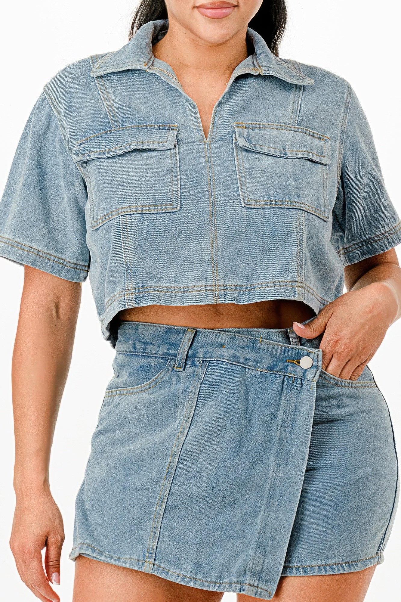 Stylish denim two-piece set featuring a cropped top and high-waisted skirt, perfect summer travel outfits for women