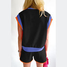 YNIQUE summer vacation two piece outfit with black top and shorts accented with blue and orange trim