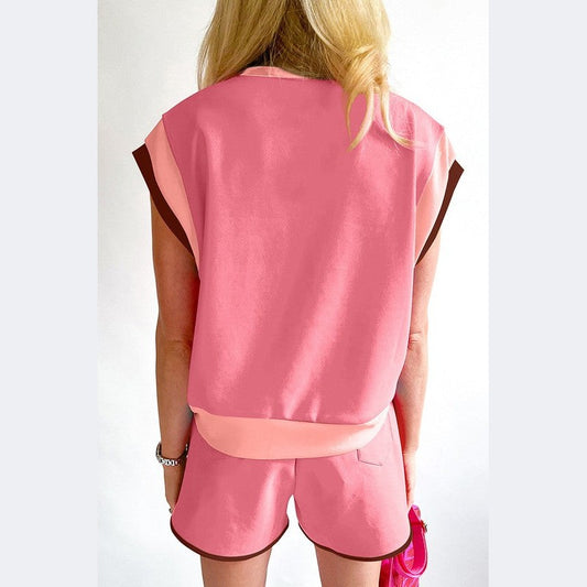 Back view of YNIQUE summer vacation two piece outfit in pink with shorts and a short sleeve top