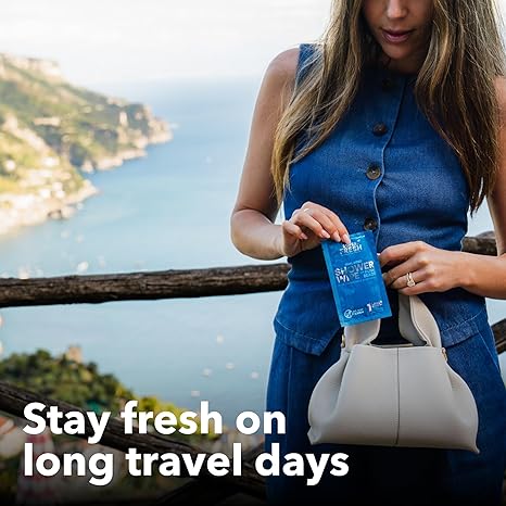 Woman taking a VacationGrabs individually wrapped gym wipes from her purse outdoors by a scenic coastline