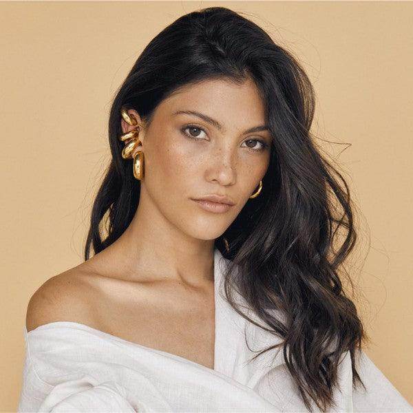 Tamara chunky hoop earrings showcased on a model with long dark hair and a natural makeup look